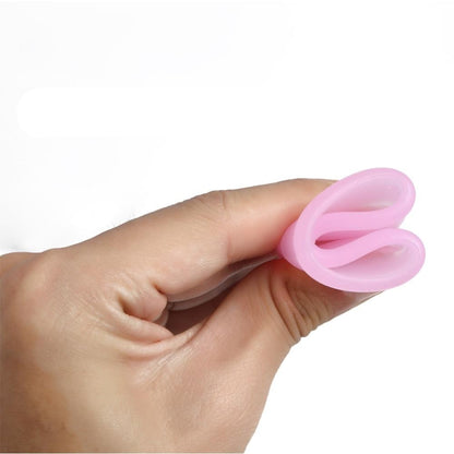 Hand holding a flexible menstrual cup demonstrating its pliability